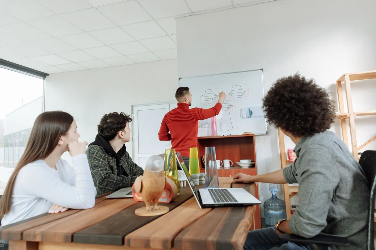 Small startup product squad planning a build at a shared workspace